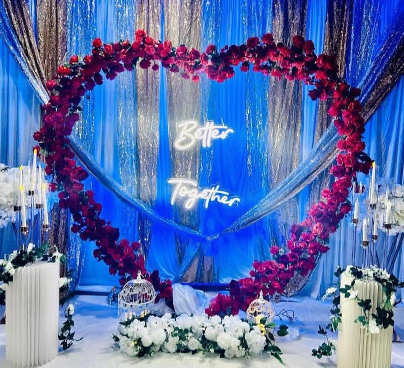 Floral heart backdrop styled for an engagement celebration