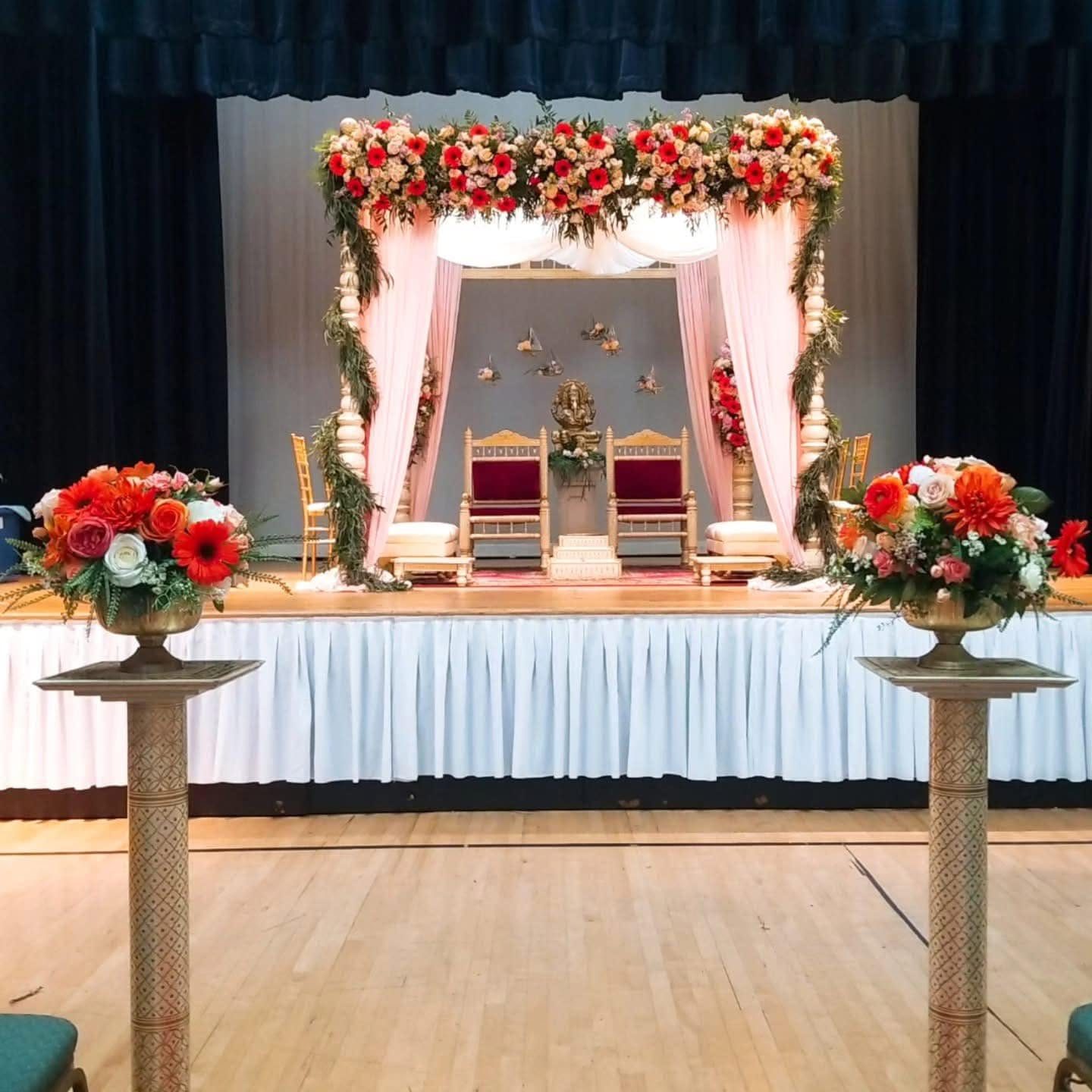 Red and white floral mandap styling for a Hindu wedding